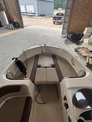 Slide: The Image of The image shows the interior of a 2016 Bayliner Element boat in a storage facility. - 8