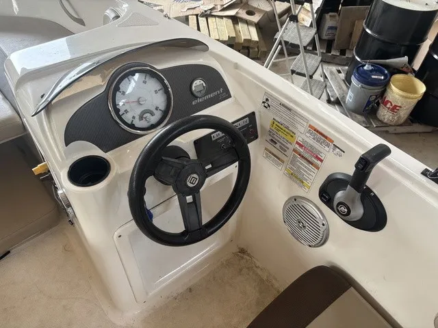 Slide: The Image of The image shows the cockpit of a 2016 Bayliner Element boat with a steering wheel and instruments. - 11