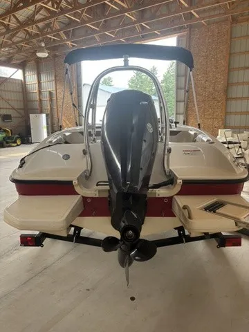 Slide: The Image of A 2016 Bayliner Element boat is in a warehouse. The outboard motor is visible. - 7