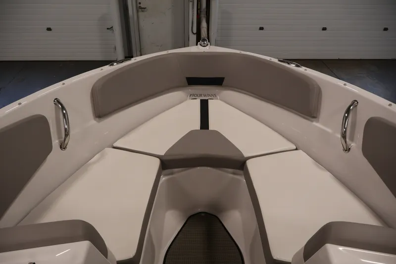 Slide: The Image of Interior view of 2017 Four Winns H190 boat, featuring cushioned seating and stainless steel handles. - 11