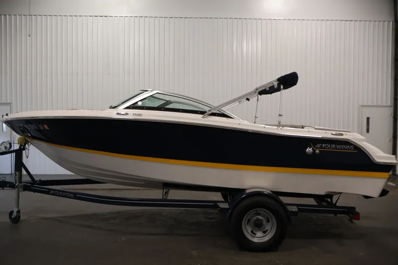 Slide: The Image of 2017 Four Winns H190 boat on trailer in indoor storage. - 8