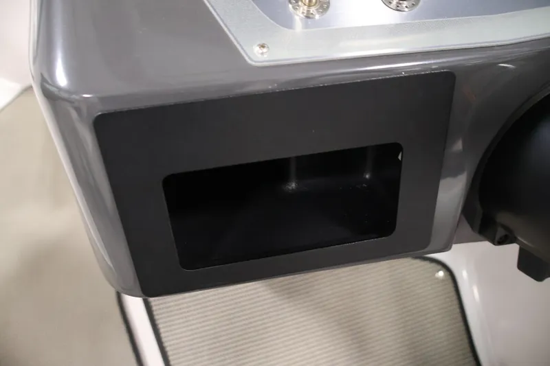 Slide: The Image of Dashboard compartment of a 2017 Four Winns H190 boat, featuring a sleek design. - 23