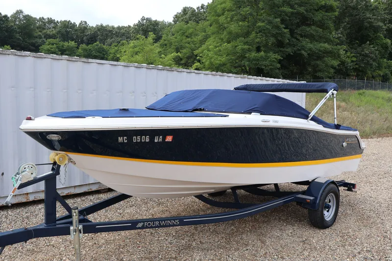 Slide: The Image of 2017 Four Winns H190 boat on trailer, covered, parked outdoors. - 55