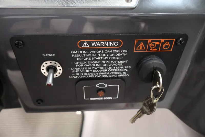 Slide: The Image of Control panel of a 2017 Four Winns H190 boat with safety warning and ignition keys. - 24
