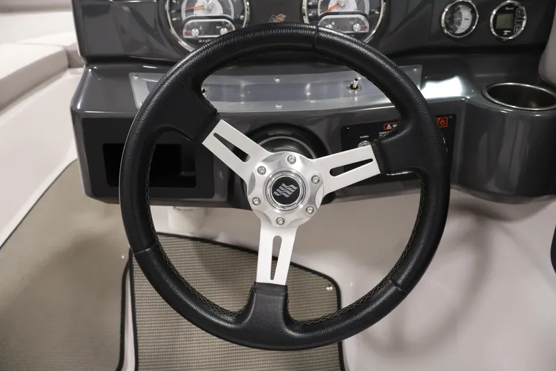 Slide: The Image of Steering wheel of 2017 Four Winns H190 boat, featuring sleek dashboard design. - 19