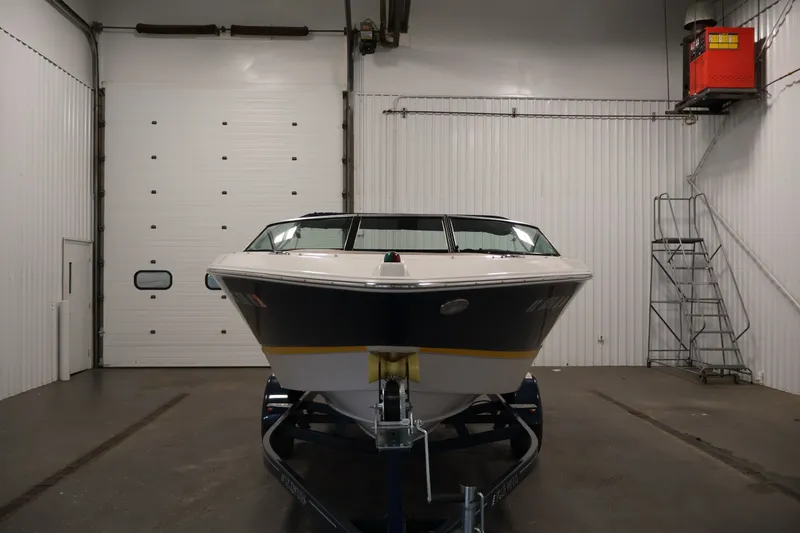 Slide: The Image of 2017 Four Winns H190 boat in a garage, front view, on a trailer. - 2