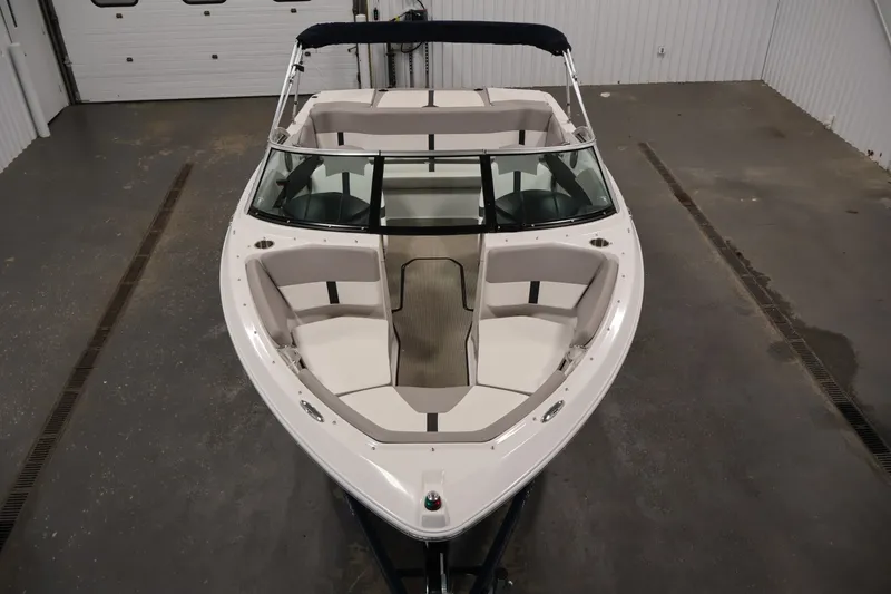 Slide: The Image of 2017 Four Winns H190 boat in indoor storage, showcasing sleek design and spacious seating. - 9