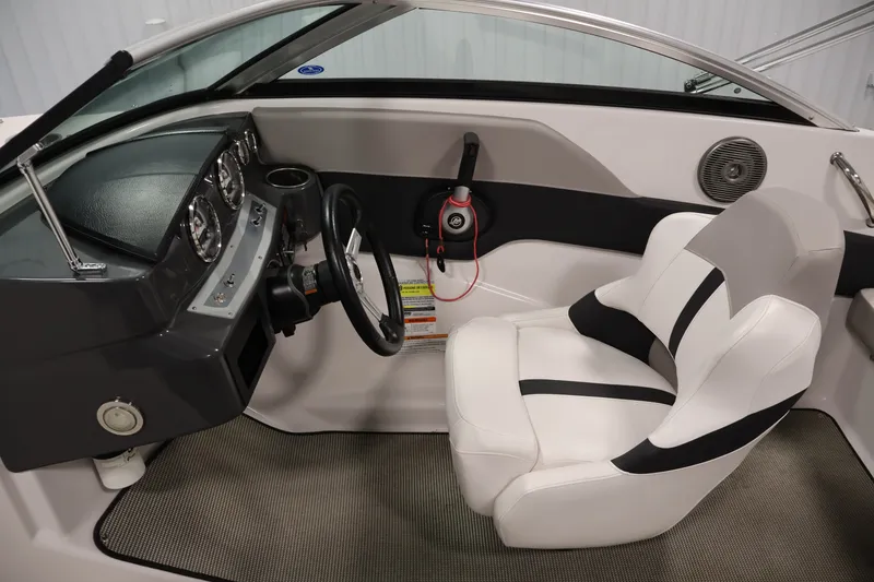 Slide: The Image of Interior of a 2017 Four Winns H190 boat, featuring a sleek dashboard and comfortable seating. - 17