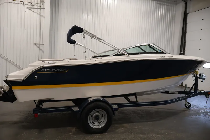Slide: The Image of 2017 Four Winns H190 boat on trailer in indoor storage. - 4