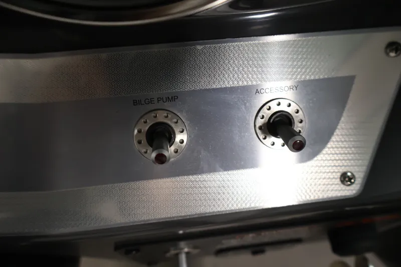 Slide: The Image of Control panel of 2017 Four Winns H190 boat with bilge pump and accessory switches. - 22