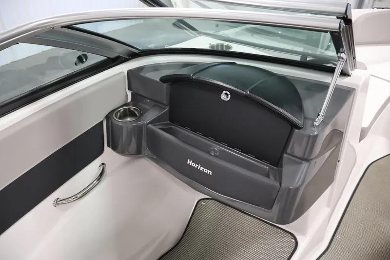 Slide: The Image of Interior of 2017 Four Winns H190 boat, featuring a sleek dashboard and cup holder. - 29