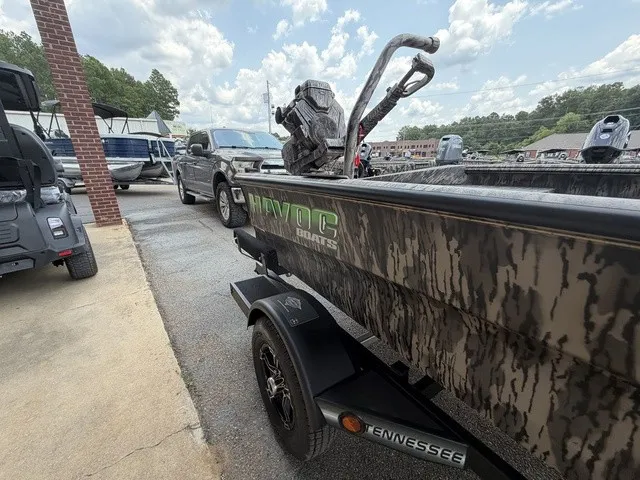 Slide: The Image of A Havoc 1756 MSTC boat on a trailer, surrounded by other vehicles and trees. - 22