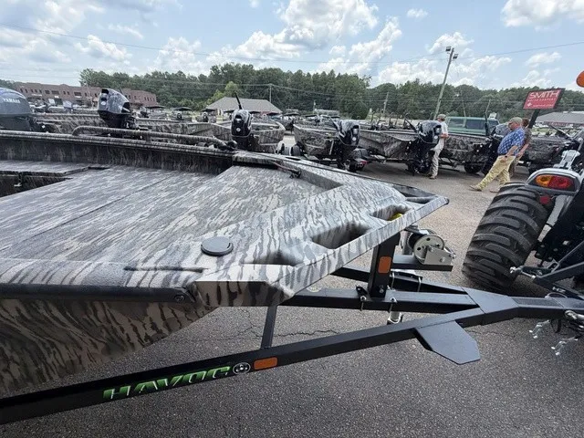 Slide: The Image of A 2026 Havoc 1756 MSTC boat on a trailer, surrounded by other boats outdoors. - 18