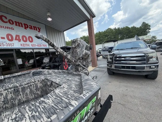 Slide: The Image of A 2026 Havoc 1756 MSTC boat is parked outside a building. A pickup truck is nearby. - 9