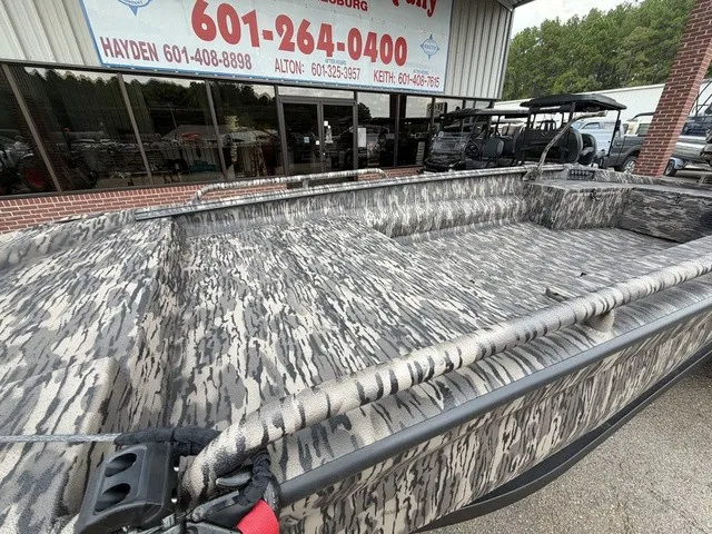 Slide: The Image of The image shows a 2026 Havoc 1756 MSTC boat with a camouflage pattern, parked in front of a store. - 5