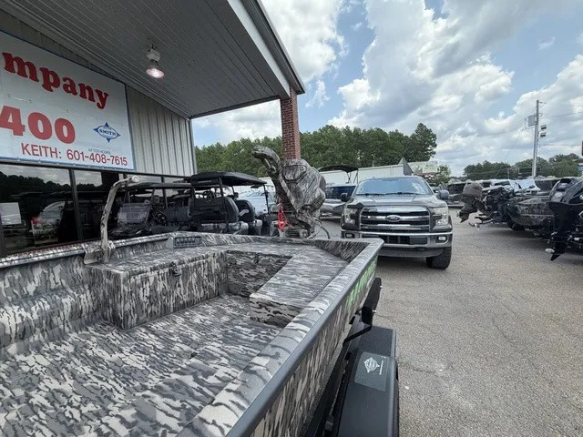 Slide: The Image of A 2026 Havoc 1756 MSTC boat with camouflage pattern, parked next to a large pickup truck under a canopy. - 8