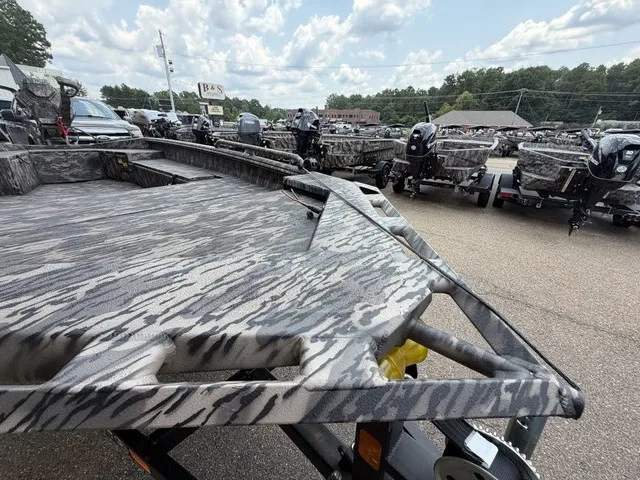 Slide: The Image of A 2026 Havoc 1756 MSTC boat with camouflage pattern, parked on a trailer in a lot. - 19