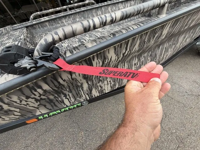 Slide: The Image of Close-up of a Havoc 1756 MSTC boat with camouflage pattern and a red SuperATV strap. - 4