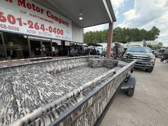 Slide: The Image of A 2026 Havoc 1756 MSTC boat is parked in front of a building. A truck is visible in the background. - 6