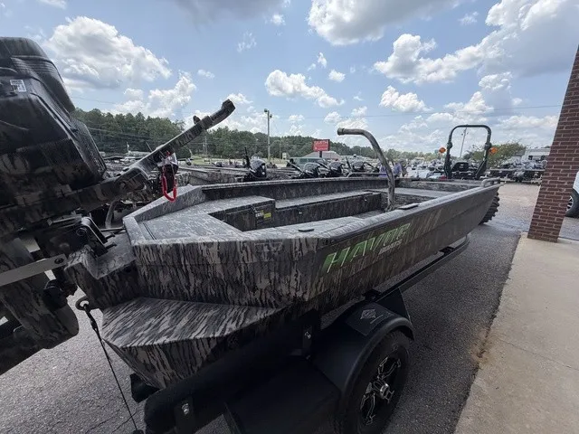Slide: The Image of The image shows a 2026 Havoc 1756 MSTC boat with a camouflage design, sitting on a trailer. - 13