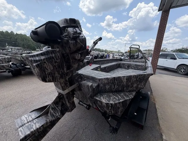 Slide: The Image of A 2026 Havoc 1756 MSTC boat with camouflage pattern, parked on a trailer, under a cloudy sky. - 12