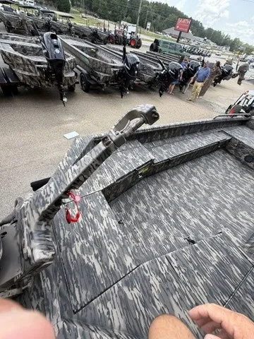 Slide: The Image of The image shows a 2026 Havoc 1756 MSTC boat with a camouflage pattern and several people in the background. - 24