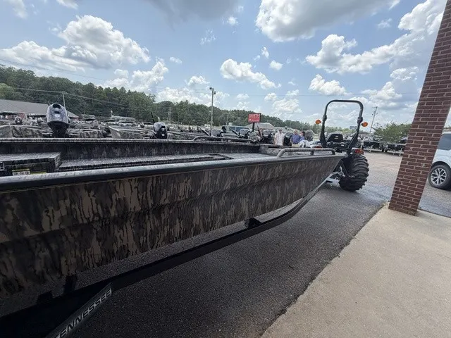 Slide: The Image of A 2026 Havoc 1756 MSTC boat with camouflage pattern, parked on a trailer under a cloudy sky. - 15