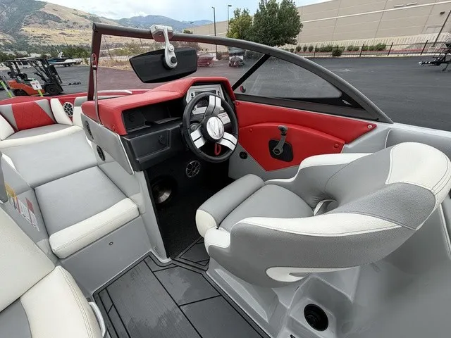 Slide: The Image of The image shows the cockpit of a 2018 Tigé R23 boat with gray and red seating. - 12