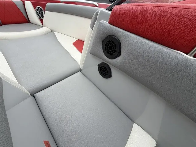 Slide: The Image of The image shows a boat interior with gray and red upholstery and speakers. - 16