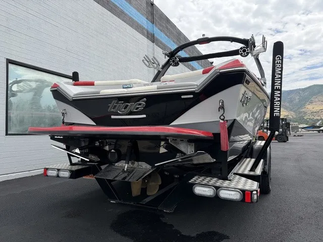 Slide: The Image of Rear view of a 2018 Tigé R23 boat on a trailer, featuring distinctive design and accessories. - 5