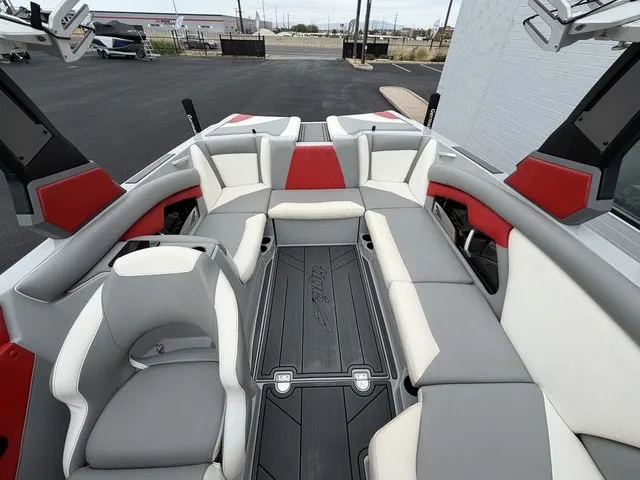 Slide: The Image of The image shows the interior of a 2018 Tigé R23 boat with gray and red seating. - 19