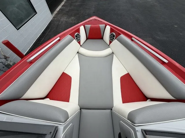 Slide: The Image of The image shows the bow of a 2018 Tigé R23 boat with gray and red upholstery. - 17