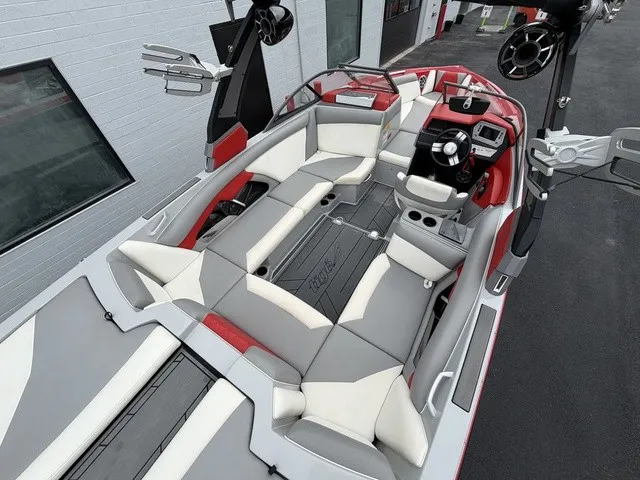 Slide: The Image of The image shows the interior of a 2018 Tigé R23 boat with gray and red seating. - 8