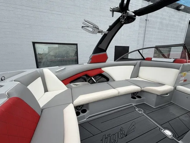 Slide: The Image of The image shows the interior of a 2018 Tigé R23 boat with gray and red seating. - 9