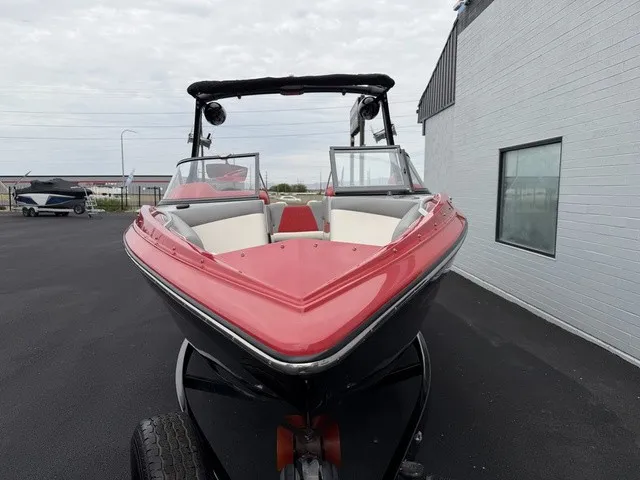 Slide: The Image of Red and black 2018 Tigé R23 sport boat, parked on a trailer in front of a building. - 4