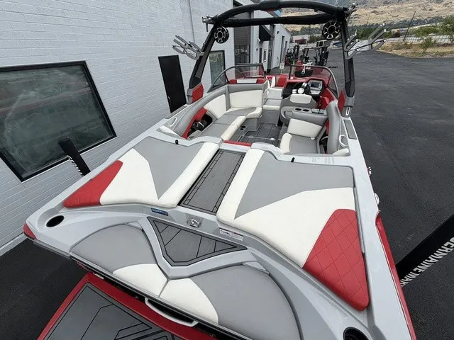 Slide: The Image of The image shows a 2018 Tigé R23 boat with red and gray upholstery. - 7