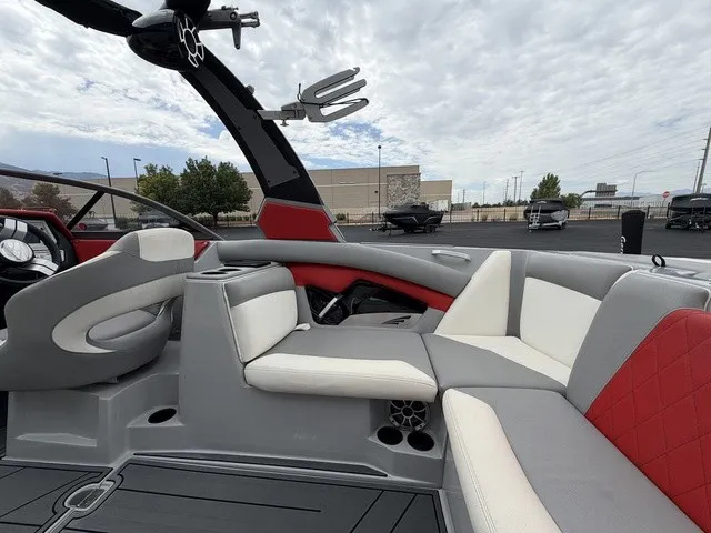 Slide: The Image of The image shows the interior of a 2018 Tigé R23 boat with gray and red seating. - 10