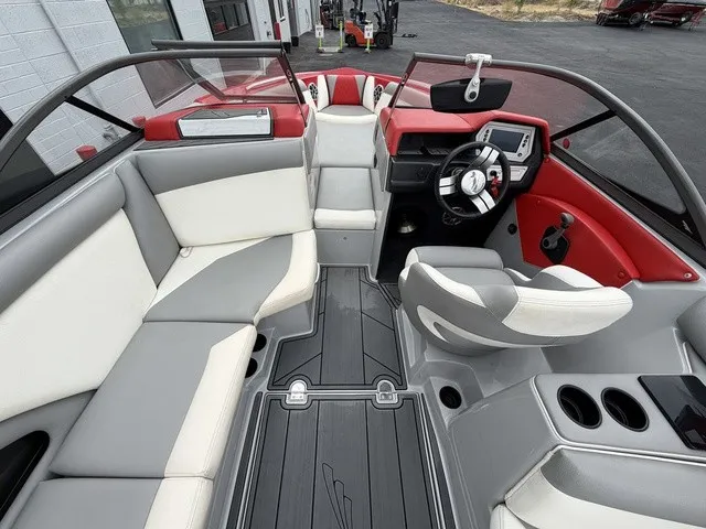 Slide: The Image of The image shows the interior of a 2018 Tigé R23 boat with gray and red accents. - 11