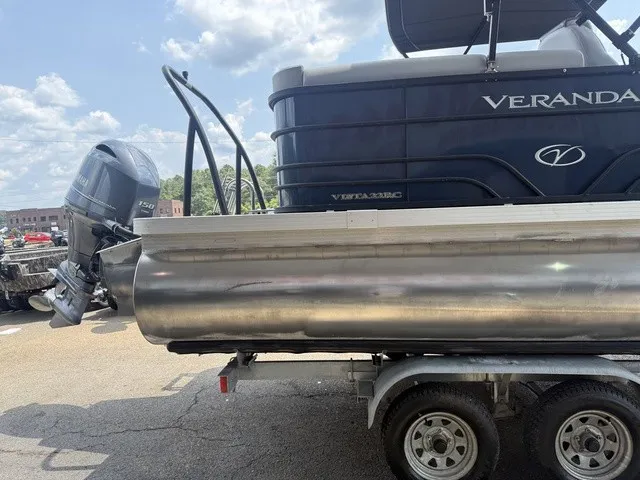 Slide: The Image of A 2022 Veranda Vista View 22RC pontoon boat on a trailer, featuring an outboard motor. - 7