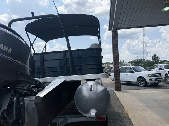 Slide: The Image of A Veranda Vista View 22RC pontoon boat with a Yamaha engine, parked under a canopy. - 12