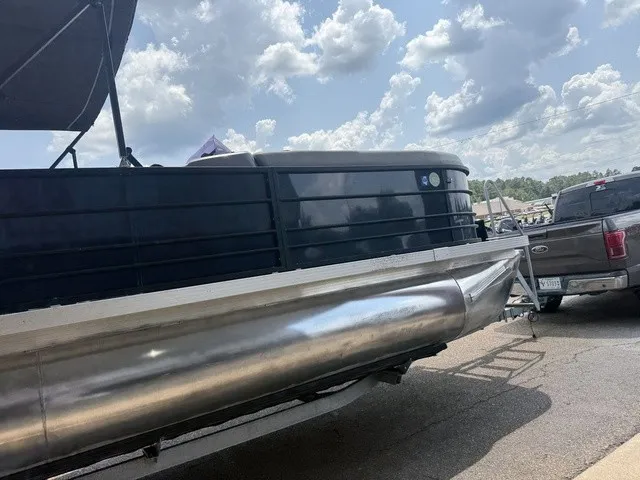 Slide: The Image of A 2022 Veranda Vista View 22RC pontoon boat on a trailer, next to a pickup truck. - 6