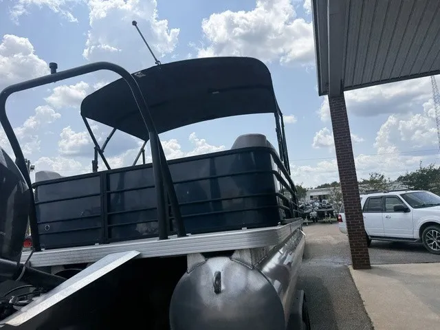 Slide: The Image of A 2022 Veranda Vista View 22RC pontoon boat on a trailer under a cloudy sky. - 11