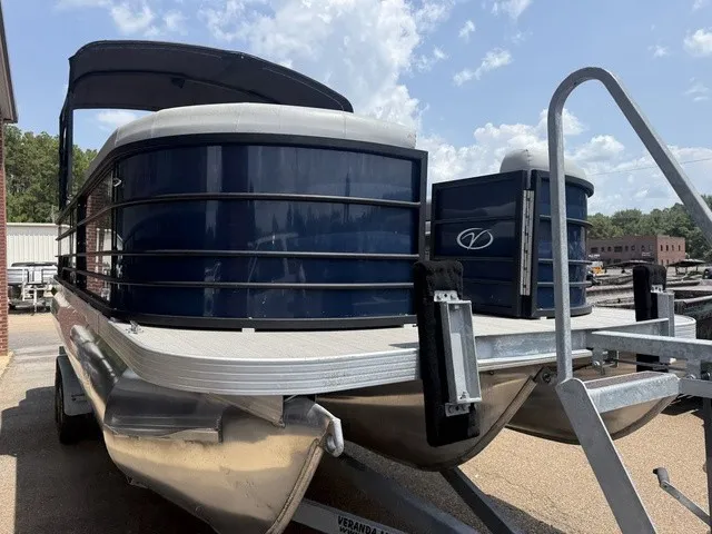 Slide: The Image of A 2022 Veranda Vista View 22RC pontoon boat on a trailer, featuring a blue hull and black canopy. - 4