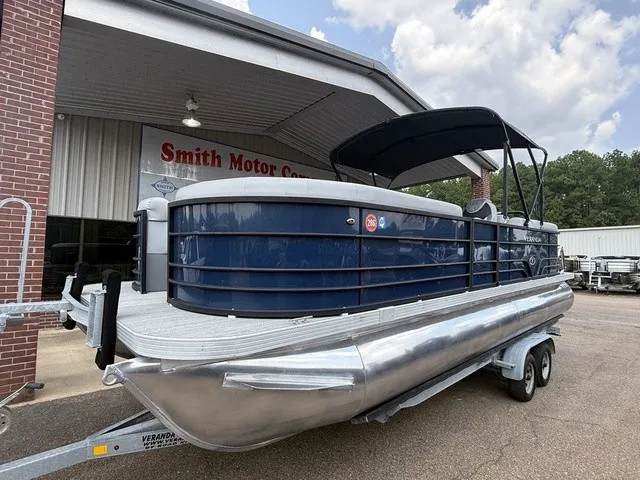 Slide: The Image of A blue 2022 Veranda Vista View 22RC pontoon boat on a trailer in front of a building. - 14
