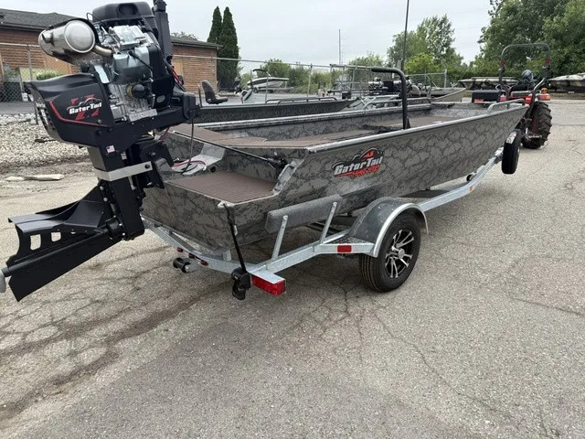 Slide: The Image of A GATOR-TAIL GB 1750 Mid Savage boat on a trailer, featuring an outboard motor. - 3