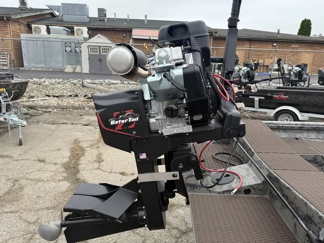 Slide: The Image of A GATOR-TAIL GB 1750 Mid Savage boat motor mounted on a trailer. Buildings are visible in the background. - 7