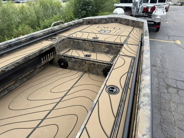 Slide: The Image of The image shows the deck of a 2026 Excel 175 SWF4 Legacy boat with camouflage pattern and storage. - 5