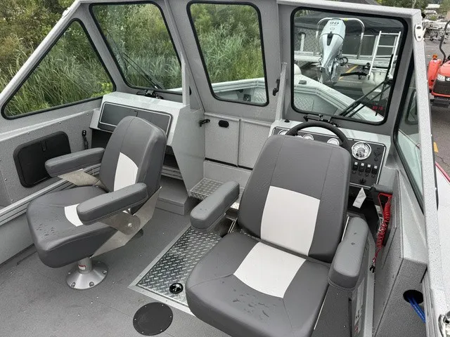 Slide: The Image of The image shows the cockpit of a Smoker Craft Phantom 20 X2 boat with two gray seats. - 6
