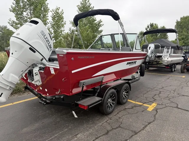 Slide: The Image of A red Smoker Craft Phantom 20 X2 boat with Suzuki outboard motor on a trailer. - 3