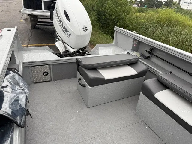 Slide: The Image of The image shows the interior of a Smoker Craft Phantom 20 X2 boat with gray seating. - 7